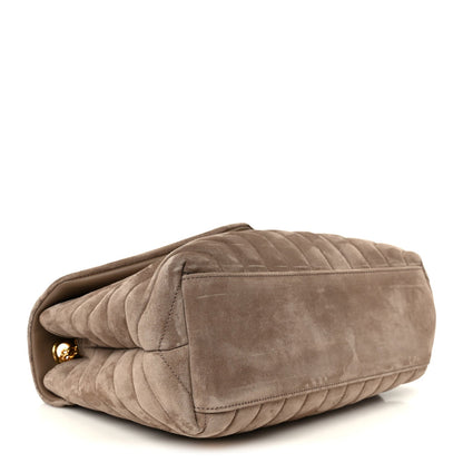 Taupe suede quilted satchel with curved flap and gold chain strap hardware