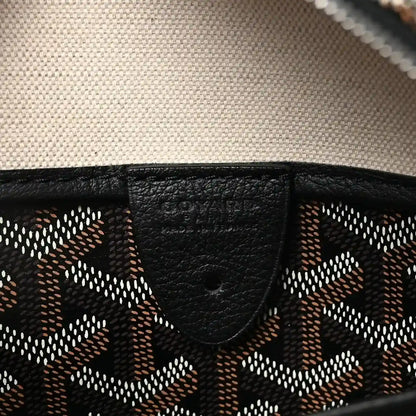 Black leather trim detail on patterned canvas tote bag.