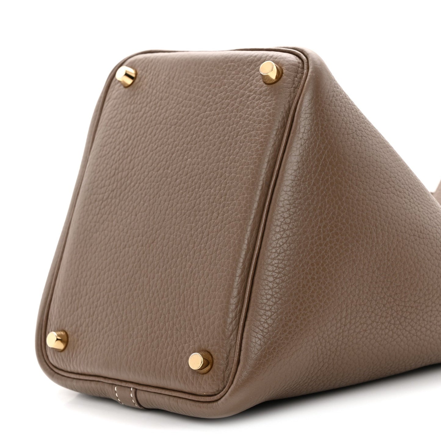 Taupe leather bucket bag with gold corner studs and curved base.