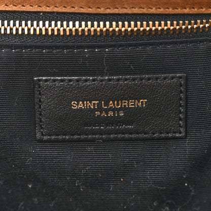 Saint Laurent interior fabric label on dark lining with gold zipper hardware.