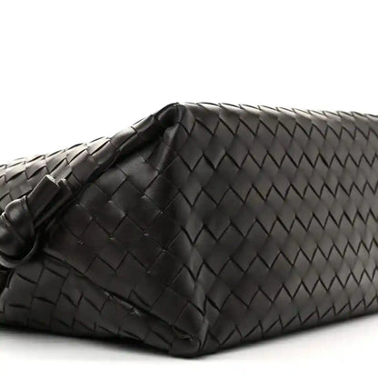 Black woven leather weekender bag end with folded corner and braided texture