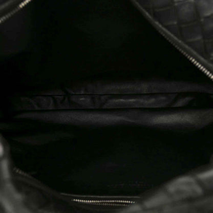 Black leather shoulder bag interior with zipper opening and stitched edge
