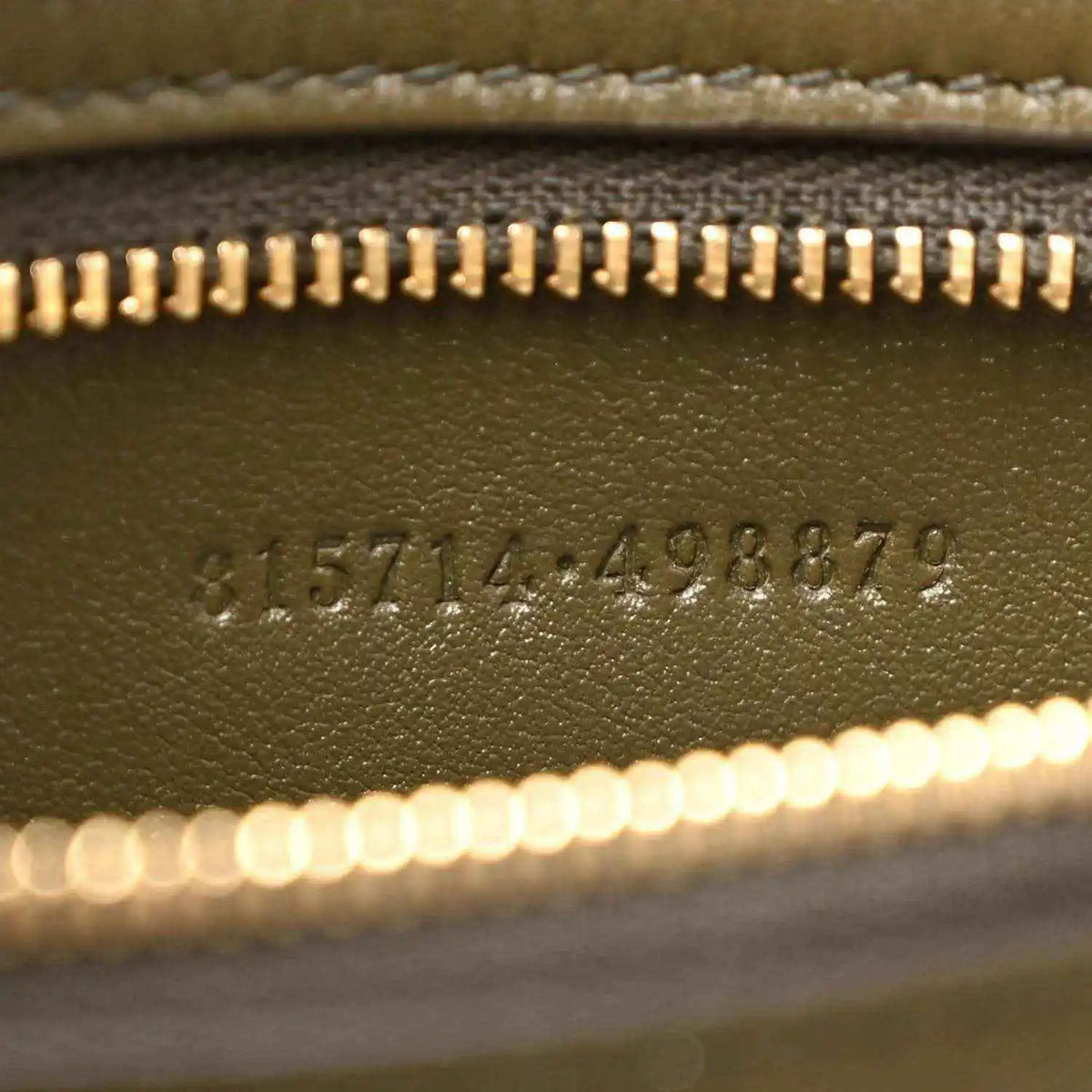 Embossed serial number detail on green leather handbag