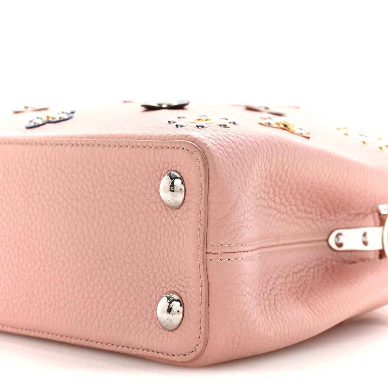 Pink leather handbag corner with snap hardware and zipper edge detail