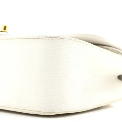 White lizard leather back with textured finish and partial gold hardware