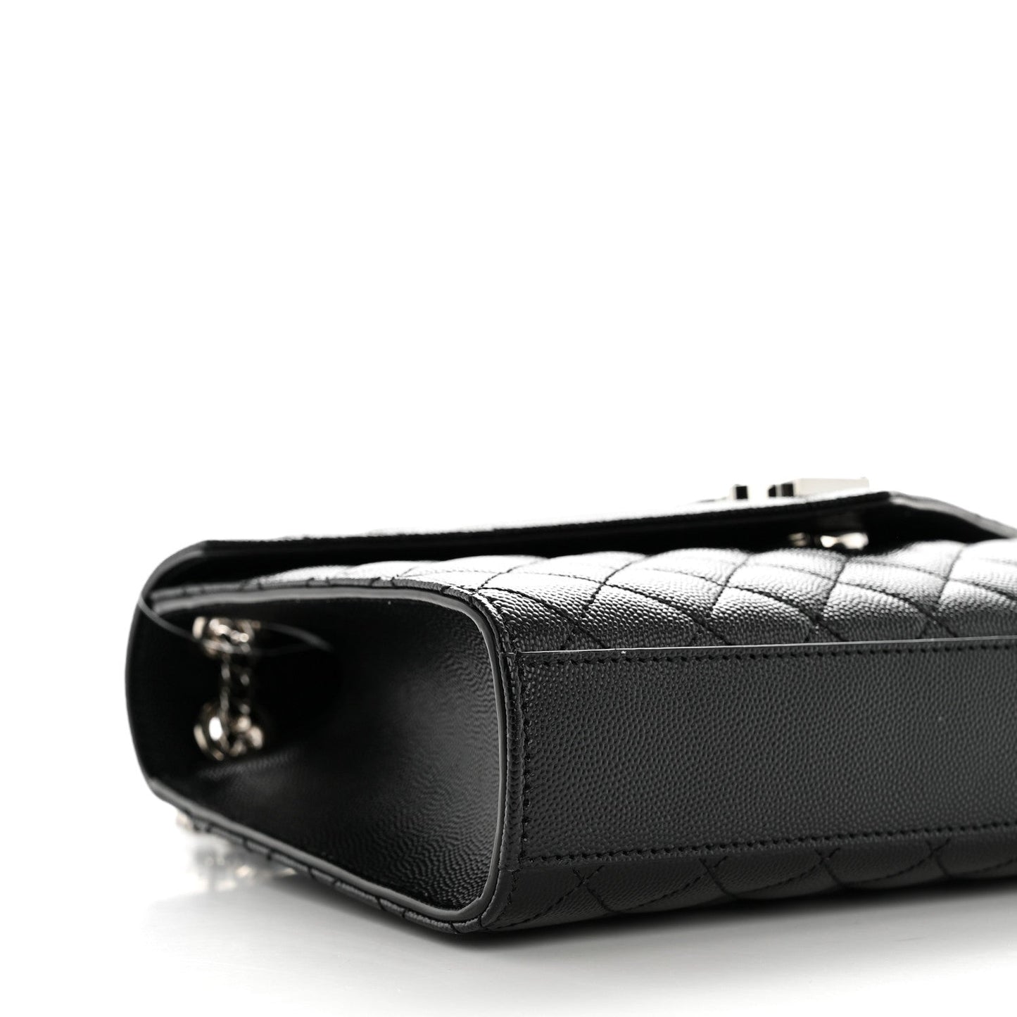 Black quilted satchel side with metal zipper pull and leather edge