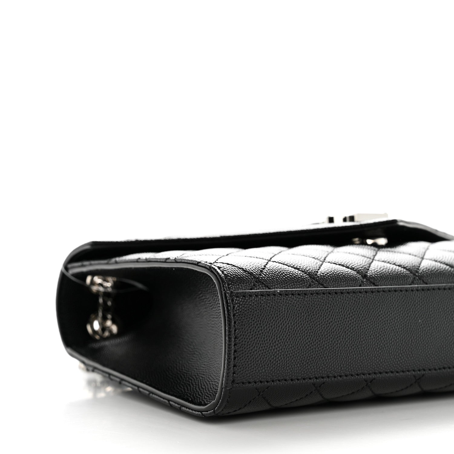 Black quilted satchel side with metal zipper pull and leather edge