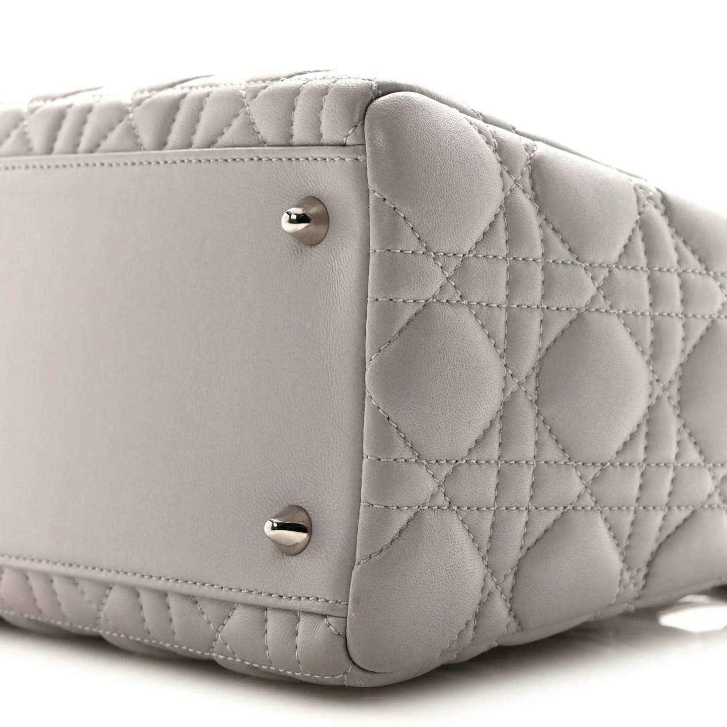 Grey quilted Lady Dior medium handbag close-up of front panel and silver snap studs