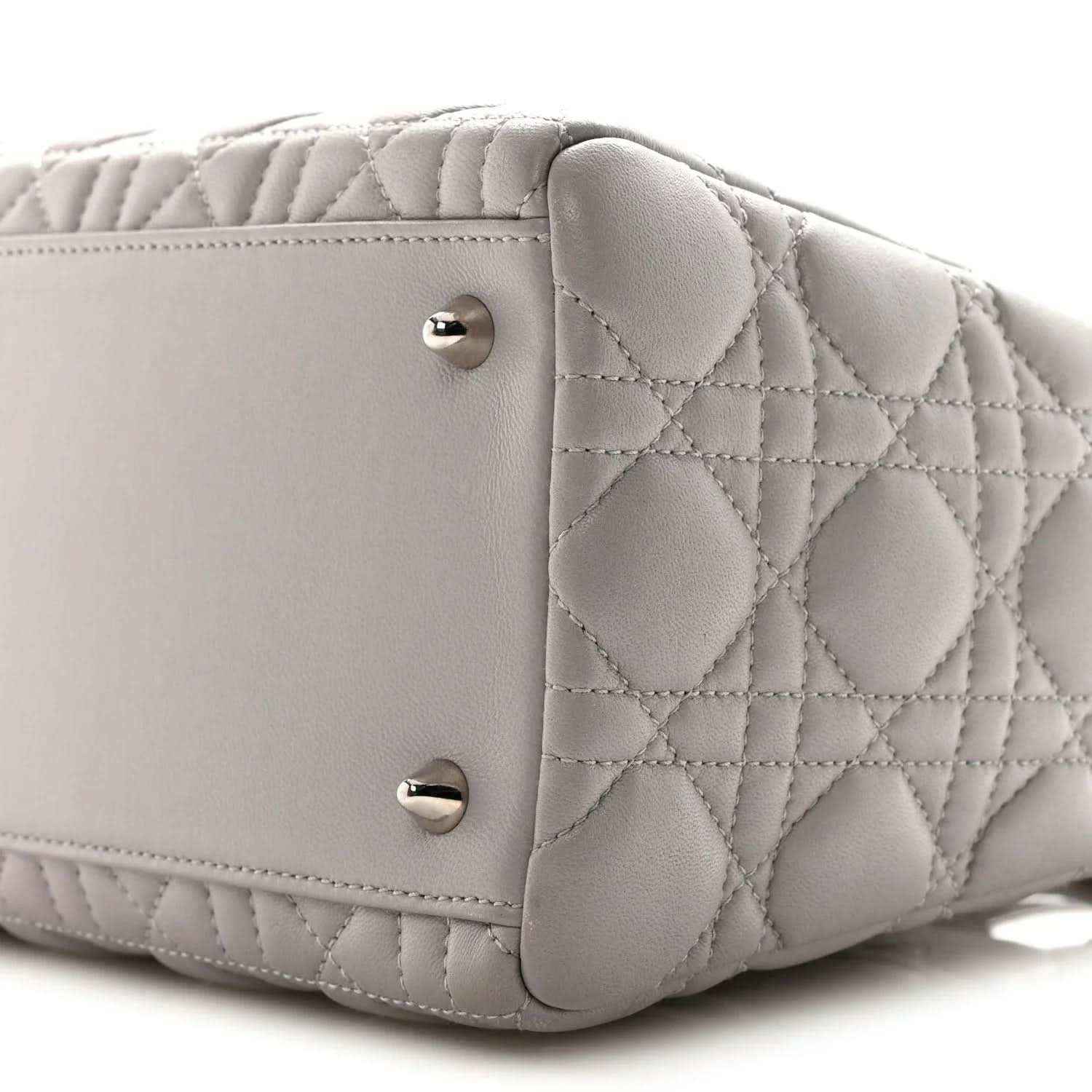 Grey quilted Lady Dior medium handbag close-up of front panel and silver snap studs