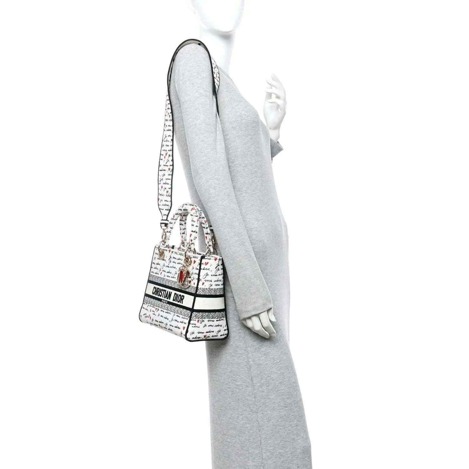 Christian Dior canvas handbag worn crossbody, “Je vous adore” print, gold hardware
