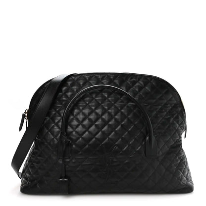 Black quilted leather travel bag with curved top handle and zip closure, gold hardware