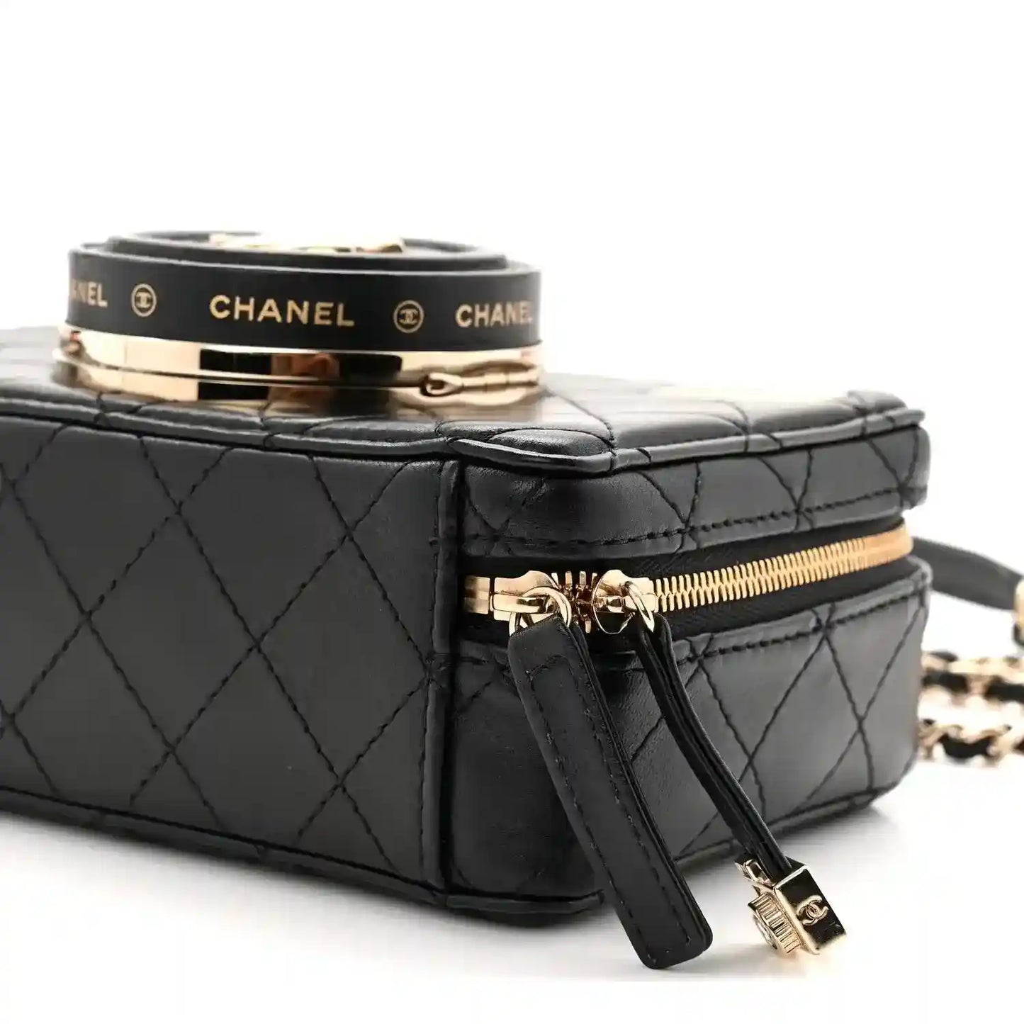 Black quilted lambskin mini bag top with clasp band, zipper pull, and wrist strap