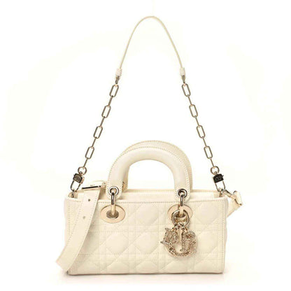 Small quilted white lambskin handbag with chain shoulder straps and charm dangle