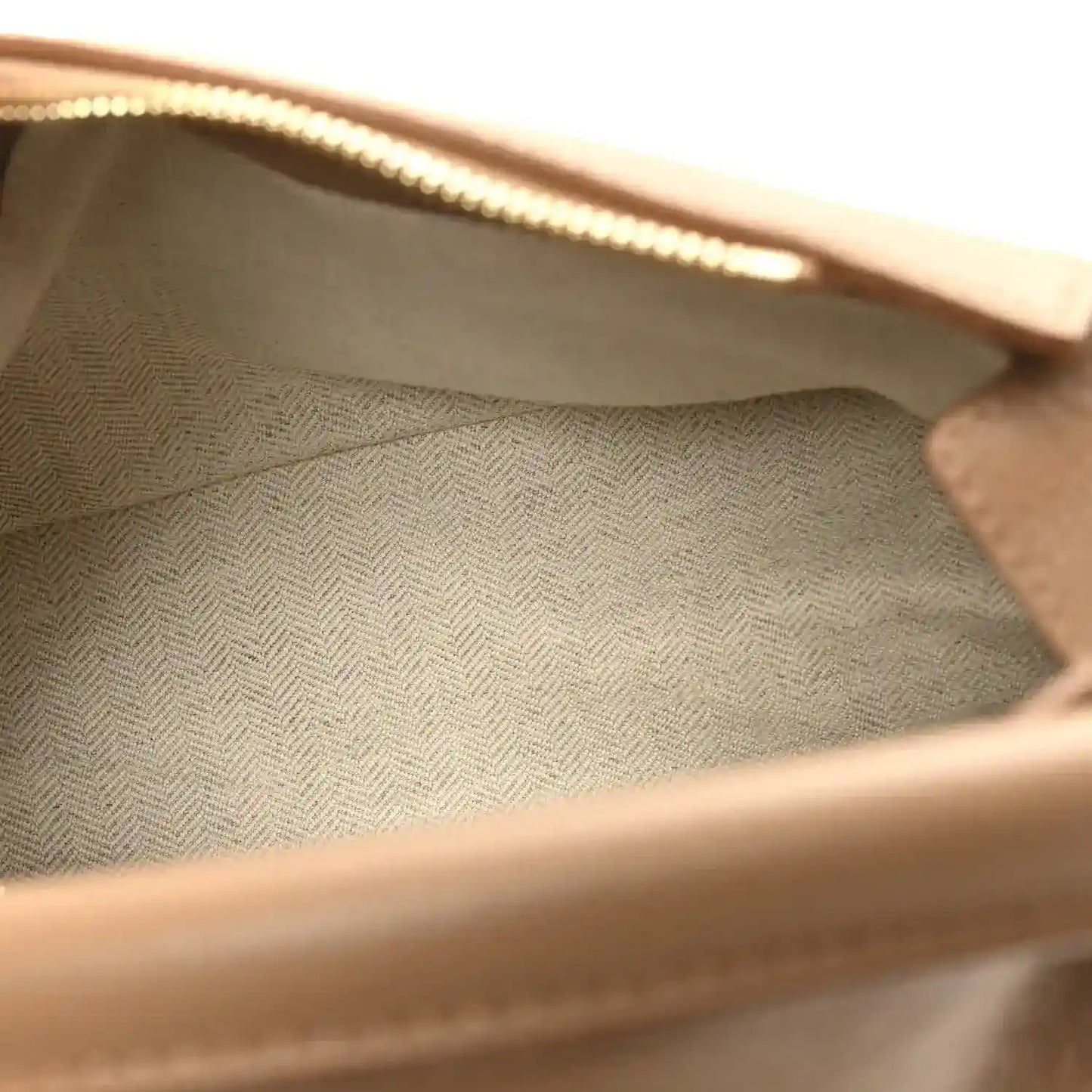 Interior lining of a small Puzzle Edge bag with zip opening and textured fabric