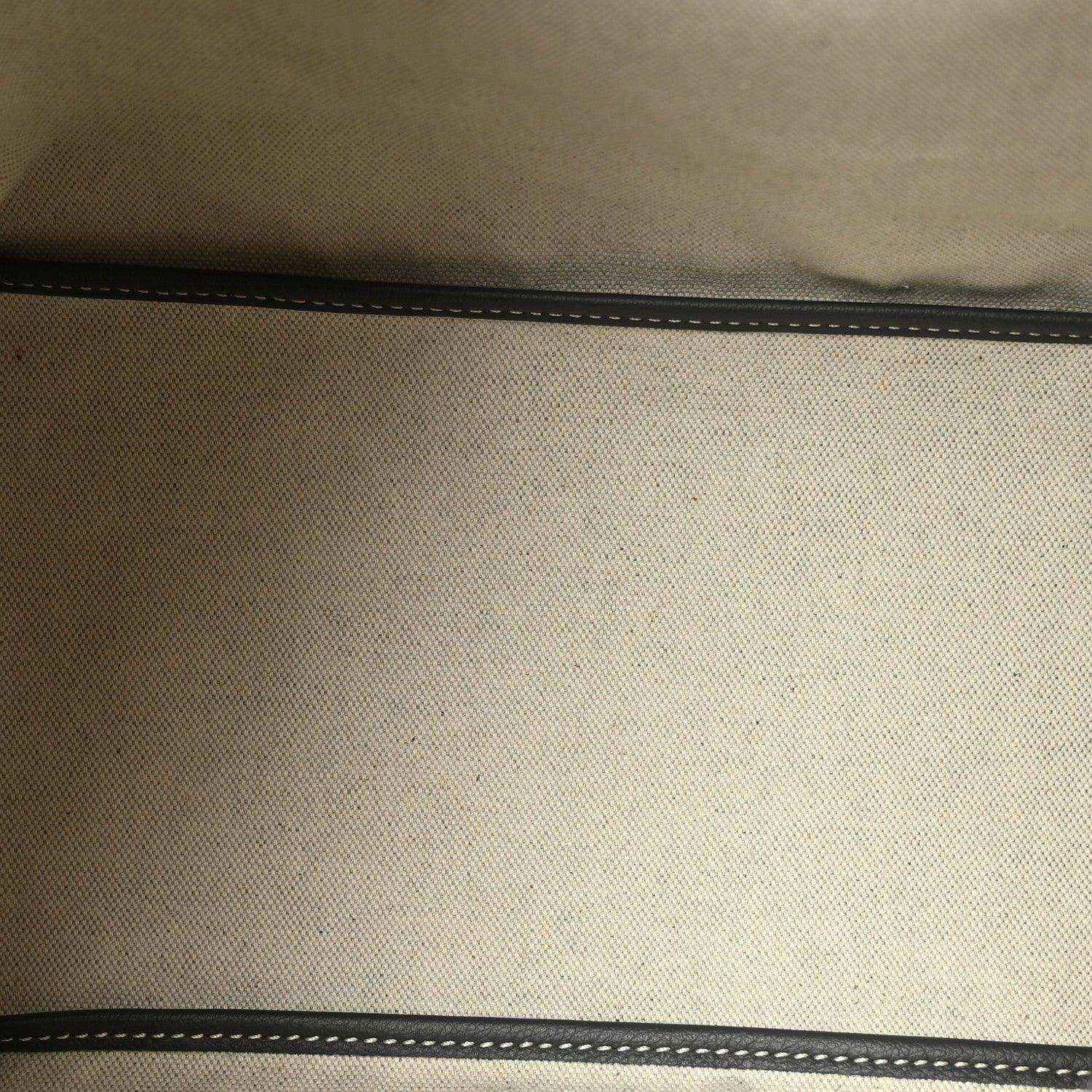 Grey canvas hobo bag detail with stitched seam and dark edge trim