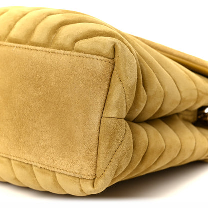 Chartreuse suede quilted satchel with curved flap and stitched edges