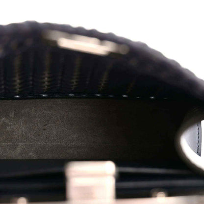 Dark leather interior with textured surface and visible stitching along an inner panel