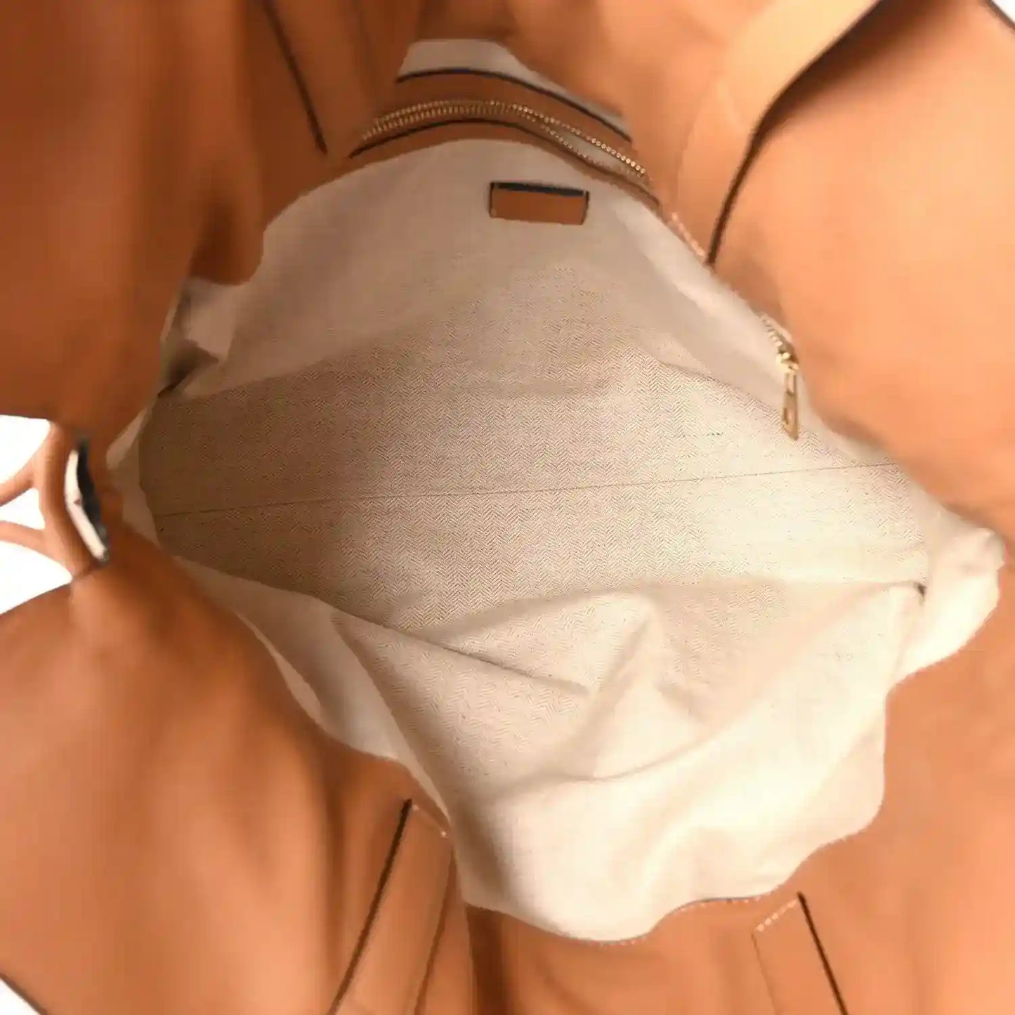 Loewe large Flamenco knot bag interior with light lining and zippered pocket.