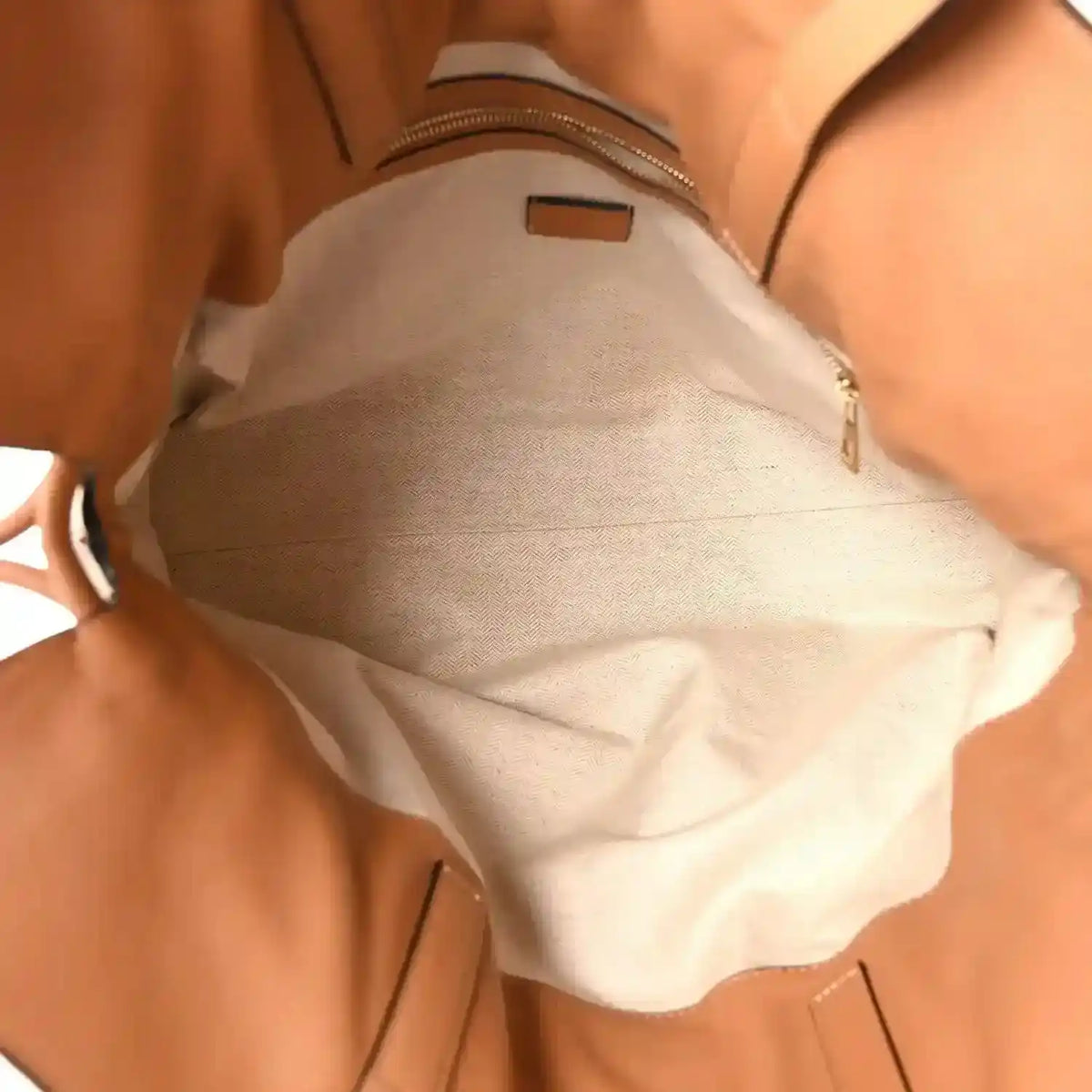 Loewe large Flamenco knot bag interior with light lining and zippered pocket.