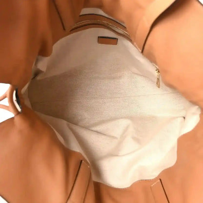 Loewe large Flamenco knot bag interior with light lining and zippered pocket.