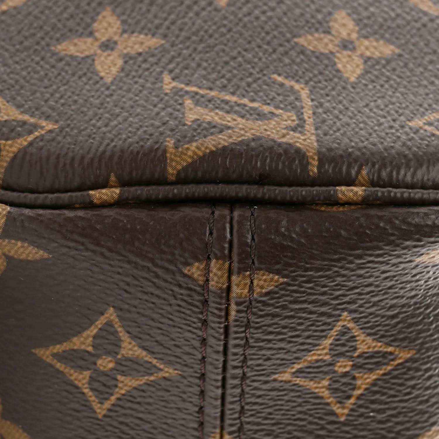 Monogram canvas zipper seam with dark leather trim and crosshatched stitching detail