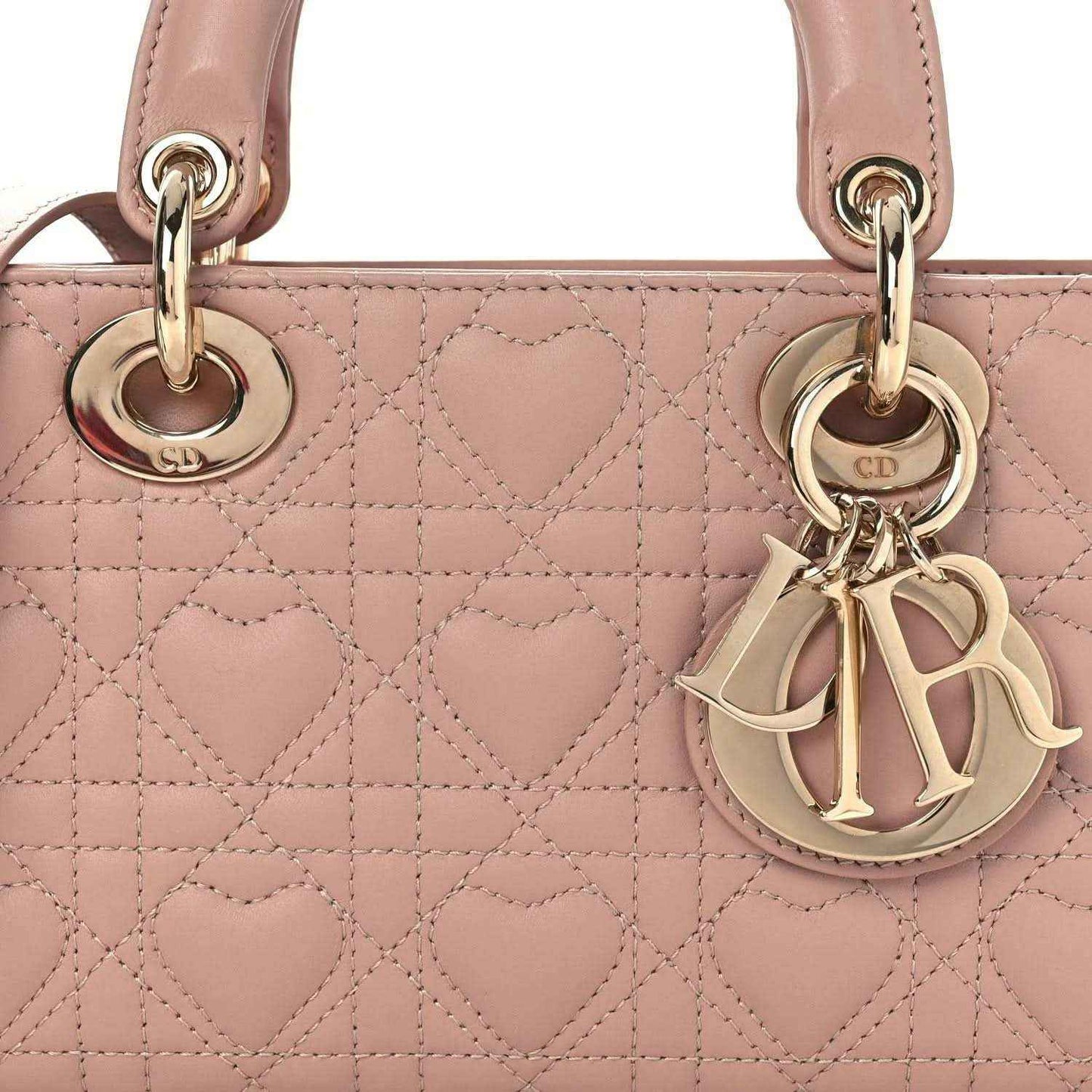 Pale pink quilted lambskin handbag front with Dior charm and gold-tone rings