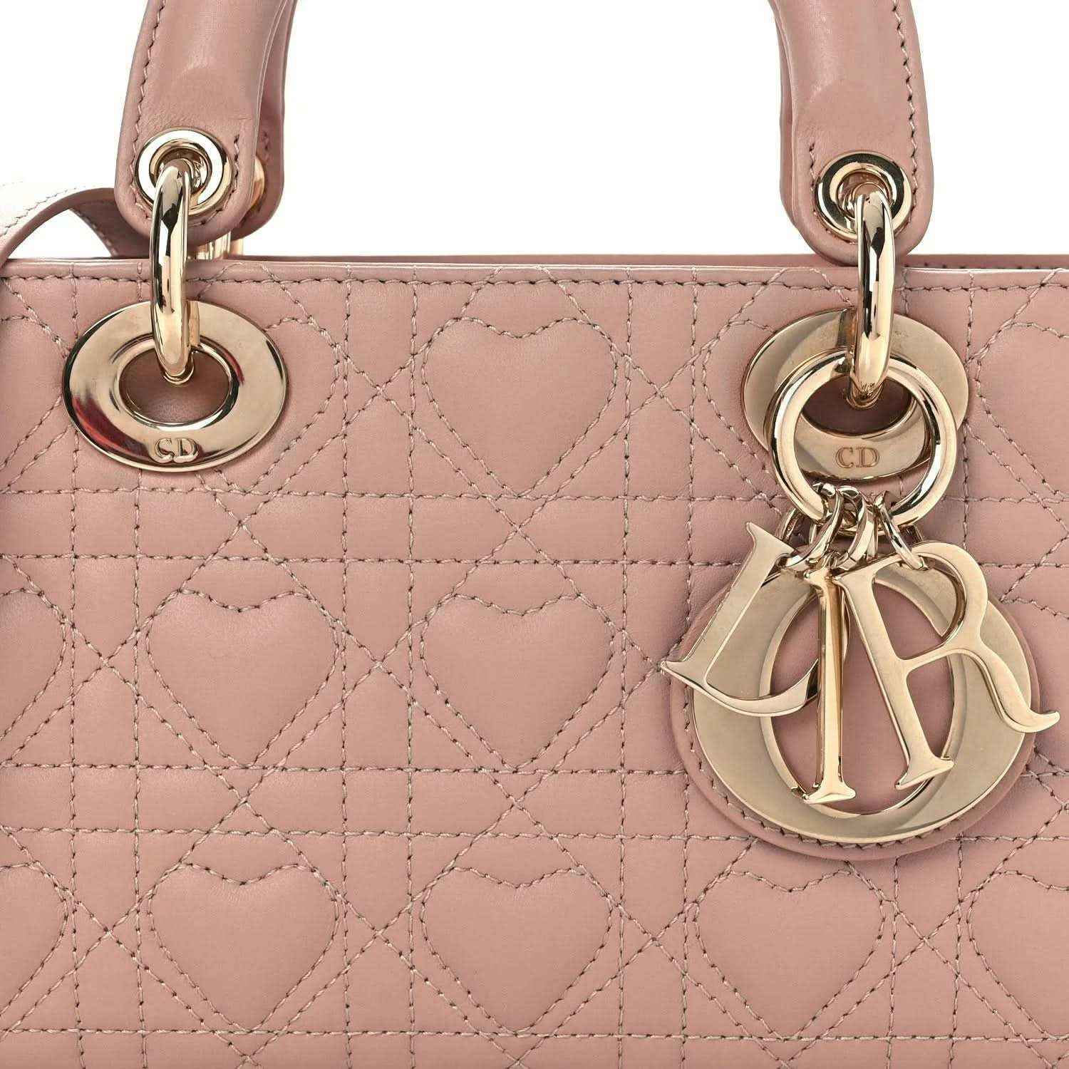 Pale pink quilted lambskin handbag front with Dior charm and gold-tone rings