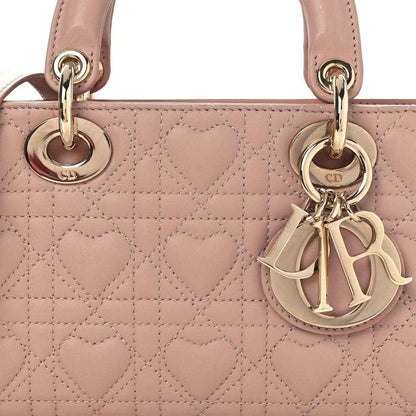 Pale pink quilted lambskin handbag front with Dior charm and gold-tone rings