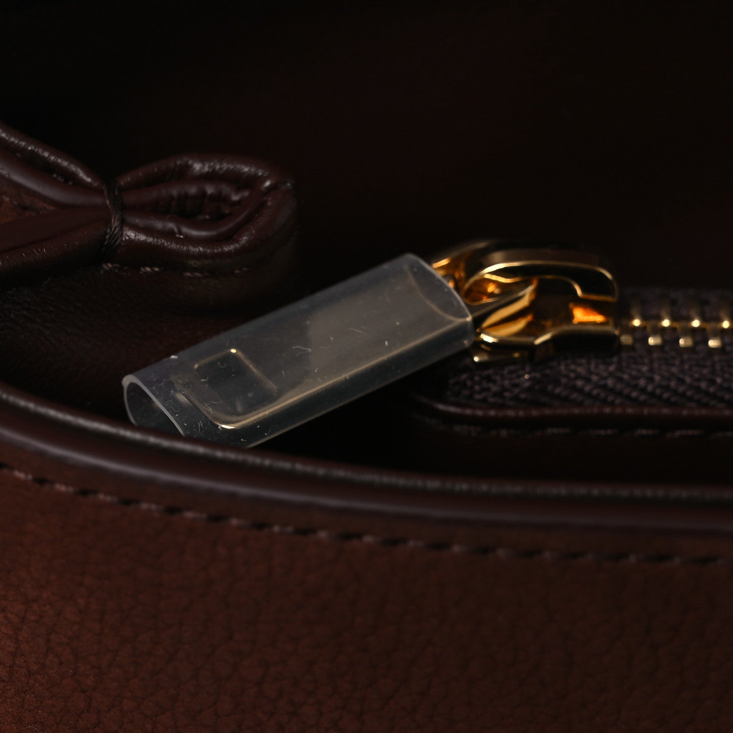 Chestnut leather bag zipper pull with gold rings and metal tab