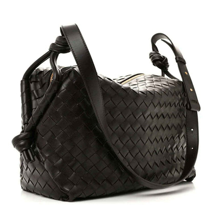 Black woven leather weekender bag with shoulder strap and top loop handle