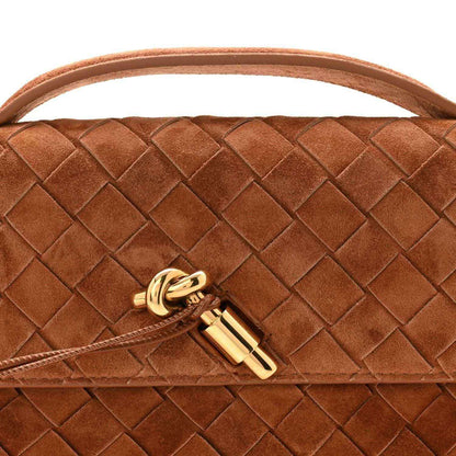 Gold-tone clasp on amber-brown suede intrecciato clutch flap