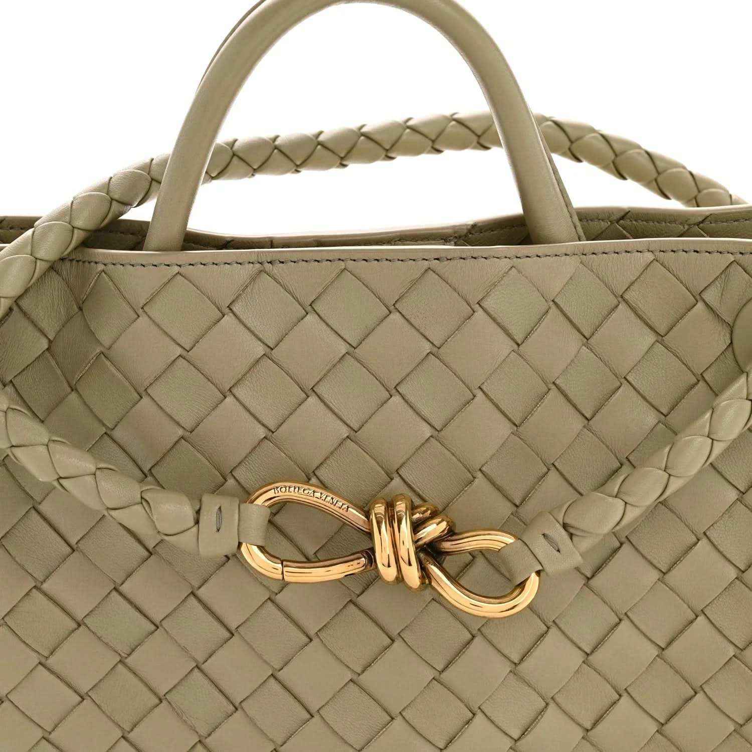 Top view of woven leather tote with gold-tone clasp and braided handles