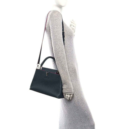 Louis Vuitton Capucines PM leather bag with top handle and shoulder strap, dark blue and fuchsia trim
