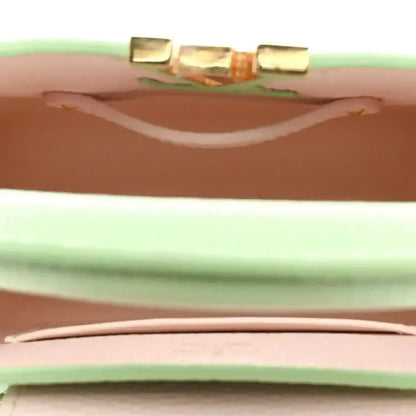 Louis Vuitton mini Capucines leather handbag, vert pomme green, close-up of top opening