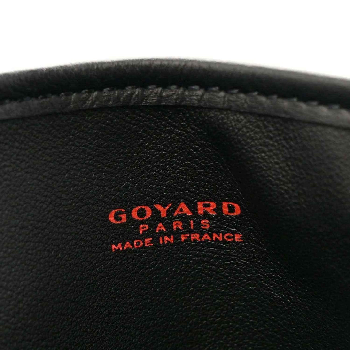 Black leather close-up with "GOYARD" "PARIS" "MADE IN FRANCE" logo