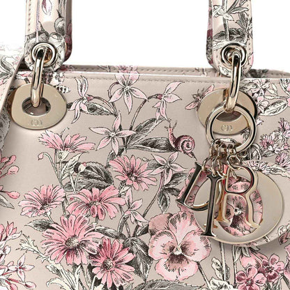 Small Lady Dior handbag front close-up with pink floral print and silver-tone clasp