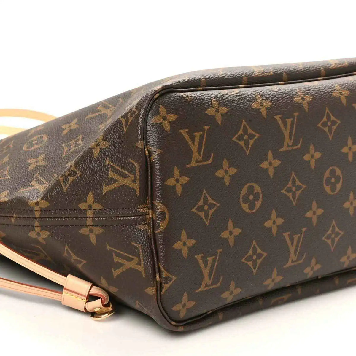 Louis Vuitton monogram tote bag side close-up, dark brown canvas with tan zipper trim