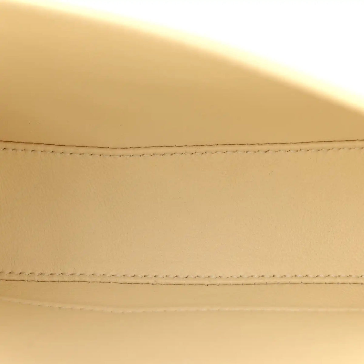Close-up of nude calfskin flap stitching and neat seam detail