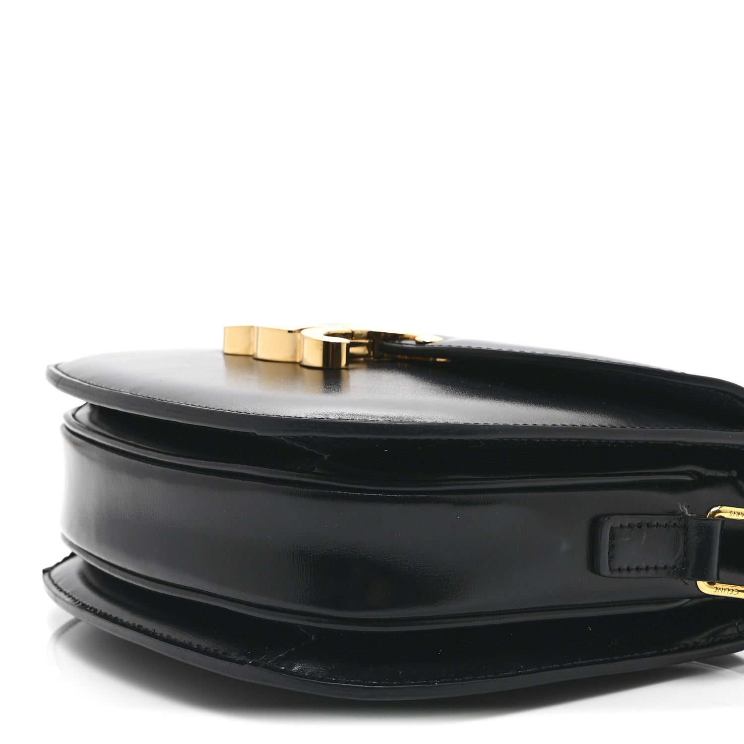 Black leather crossbody bag side view with gold-tone clasp and adjustable strap ring