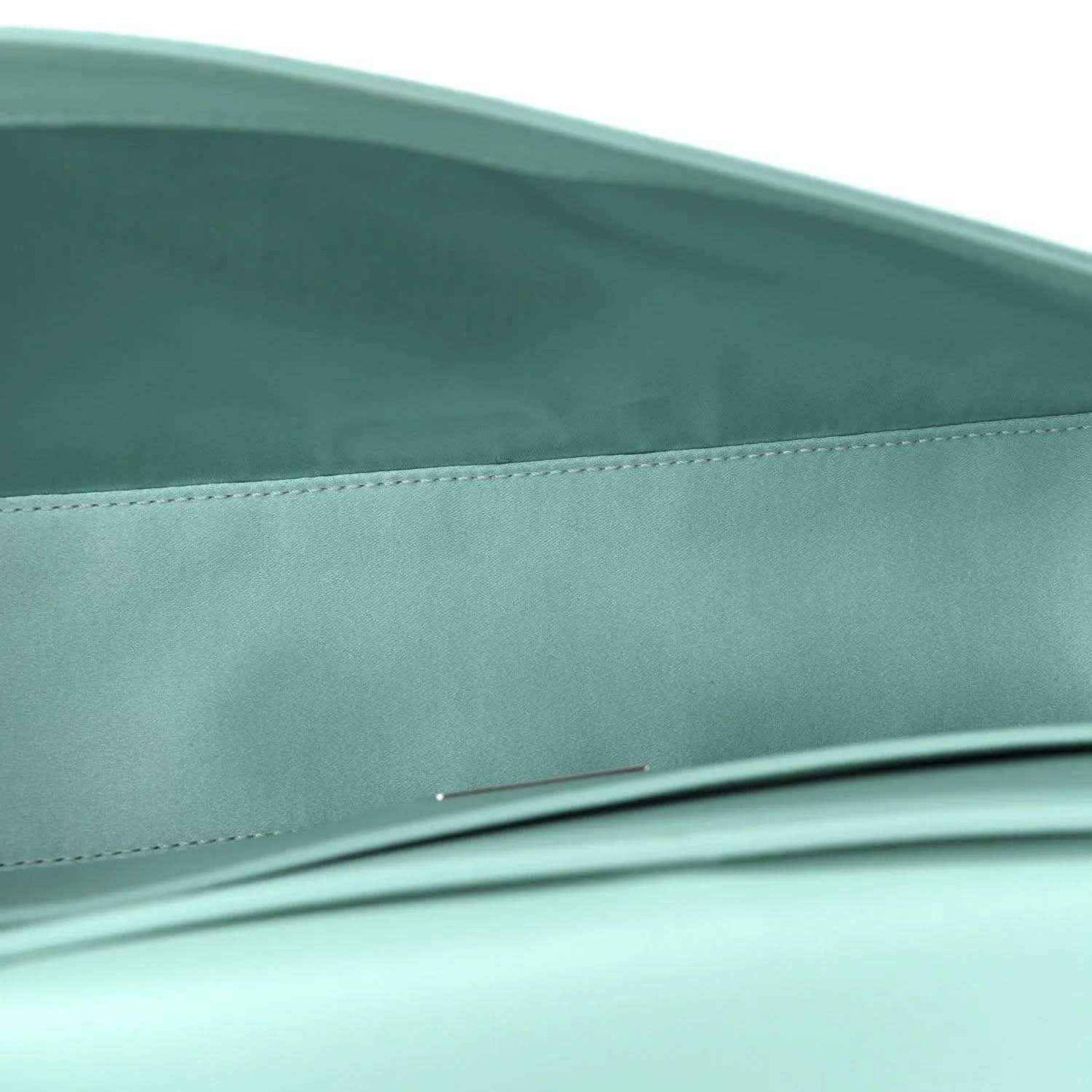 Blue satin baguette bag close-up of front edge and top seam detail