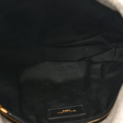 Interior lining close-up with brand label on quilted satchel