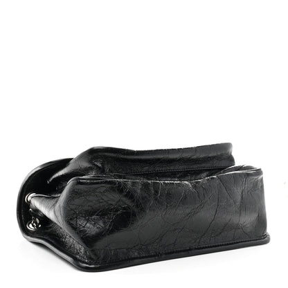 Black medium chain satchel side profile with crinkled calfskin and silver ring