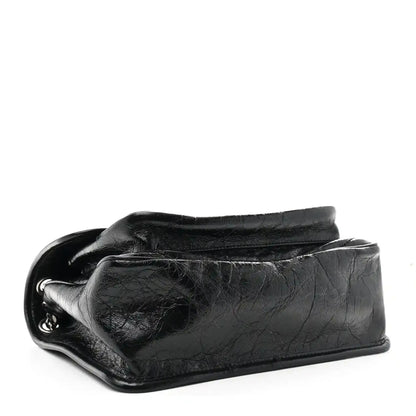 Black medium chain satchel side profile with crinkled calfskin and silver ring