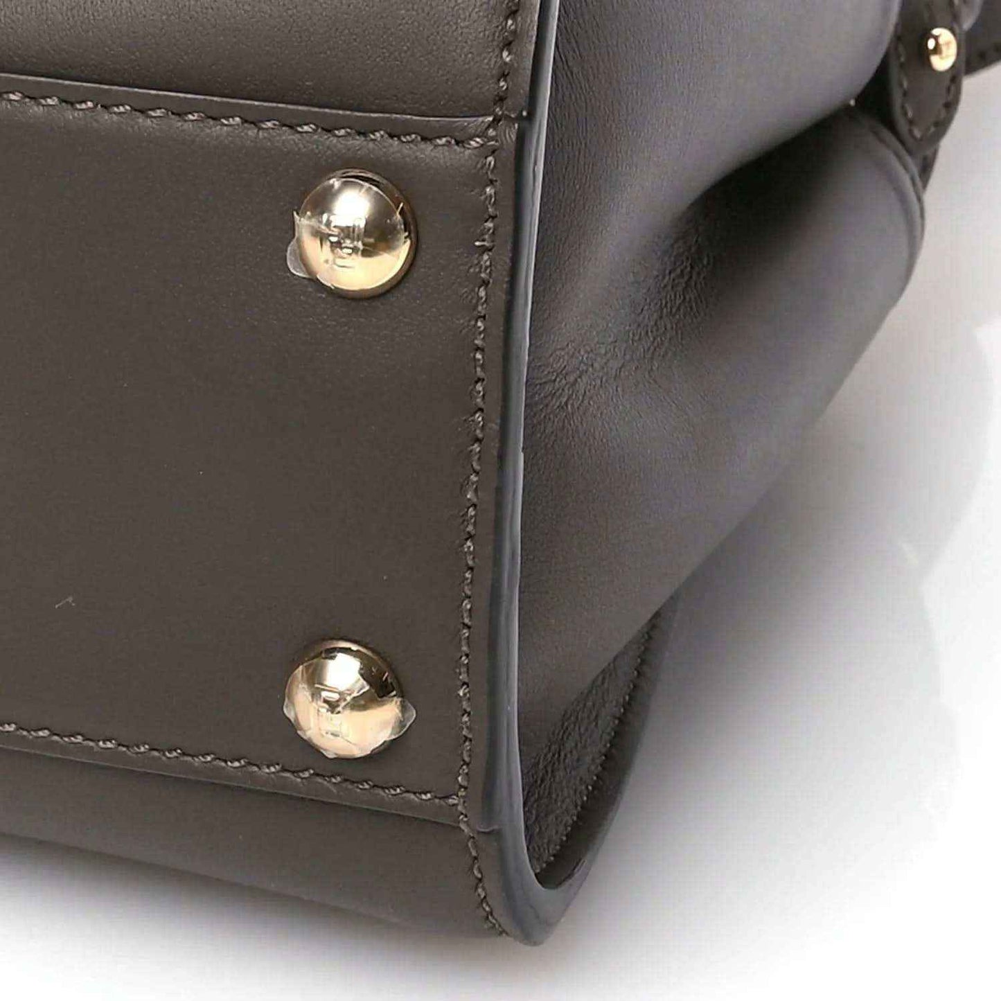 Mini Peekaboo satchel close-up with dark brown suede and gold snap hardware