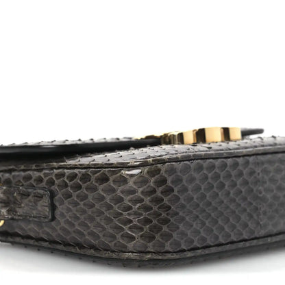 Grey snakeskin bag bottom edge with gold-tone hardware and stitching