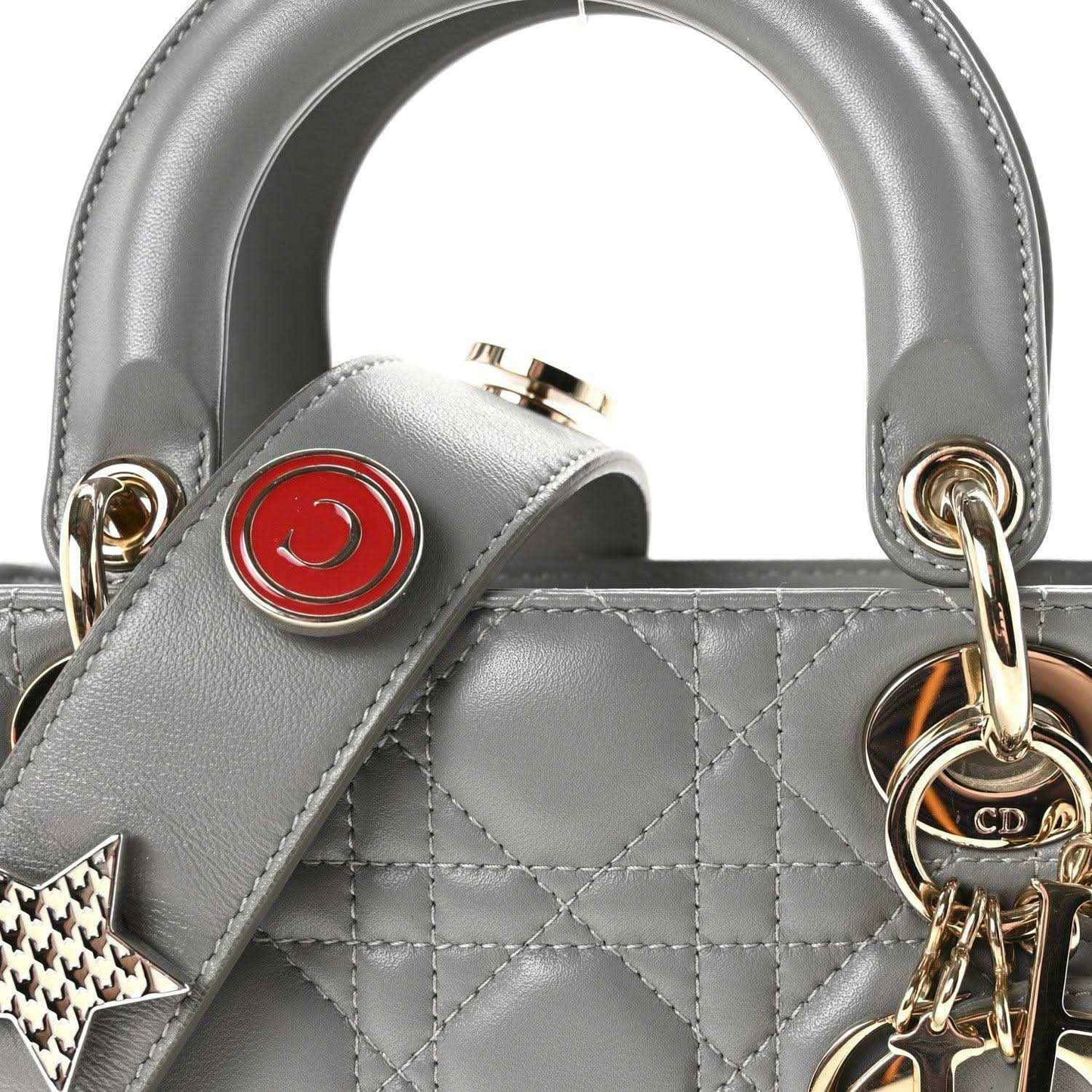 Grey quilted Lady Dior top handle with gold rings, red emblem, and star key charm