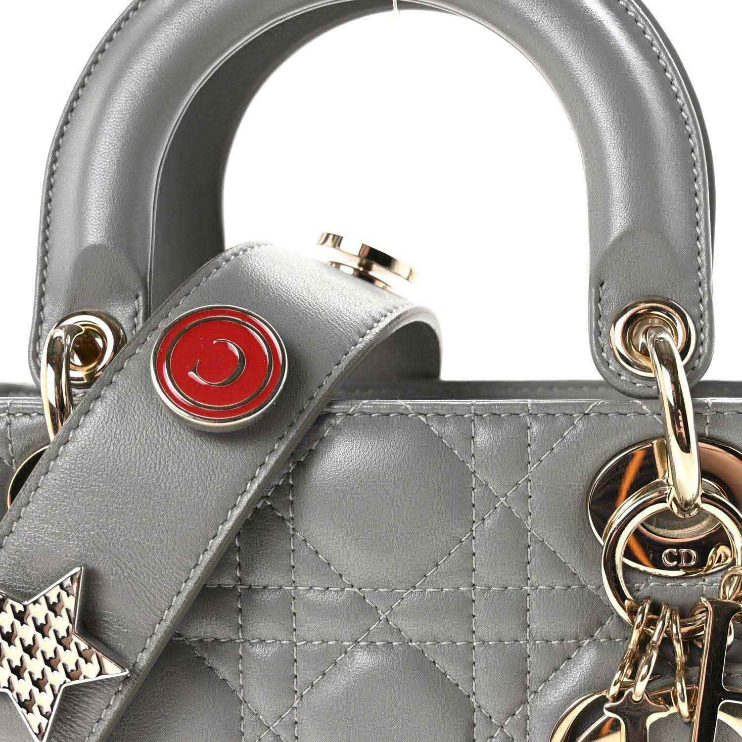 Grey quilted Lady Dior top handle with gold rings, red emblem, and star key charm
