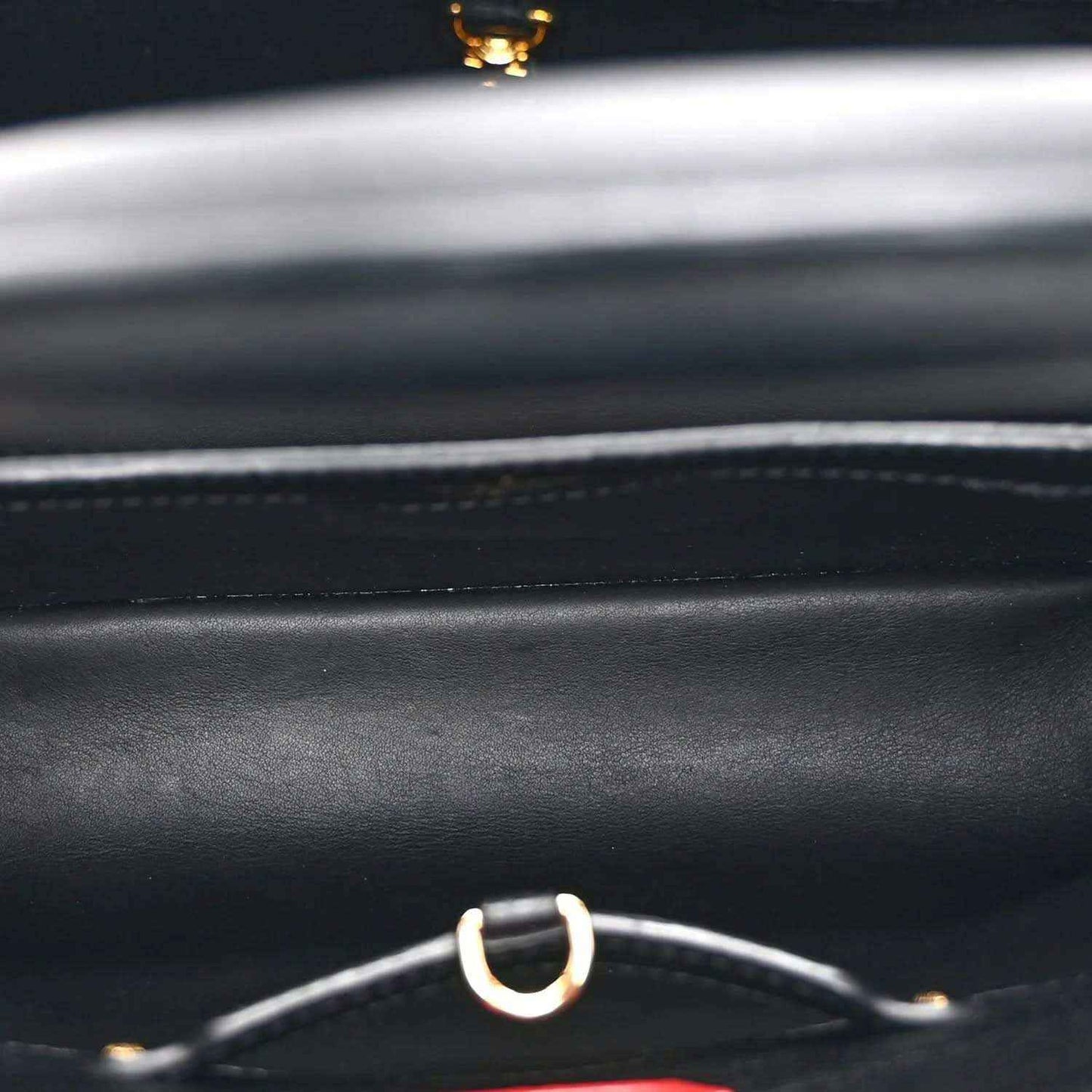 Black handbag leather with silver ring strap hardware and gold accent detail