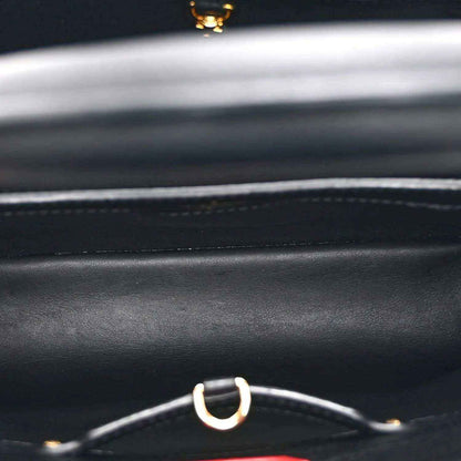 Black handbag leather with silver ring strap hardware and gold accent detail