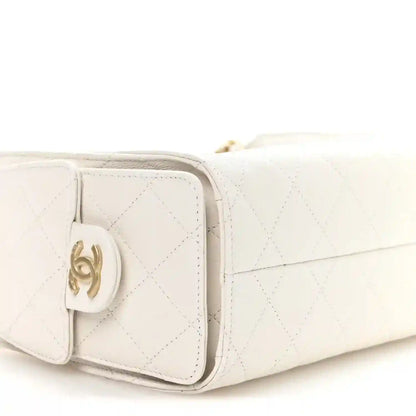 White quilted mini handbag side close-up with CC turn-lock hardware